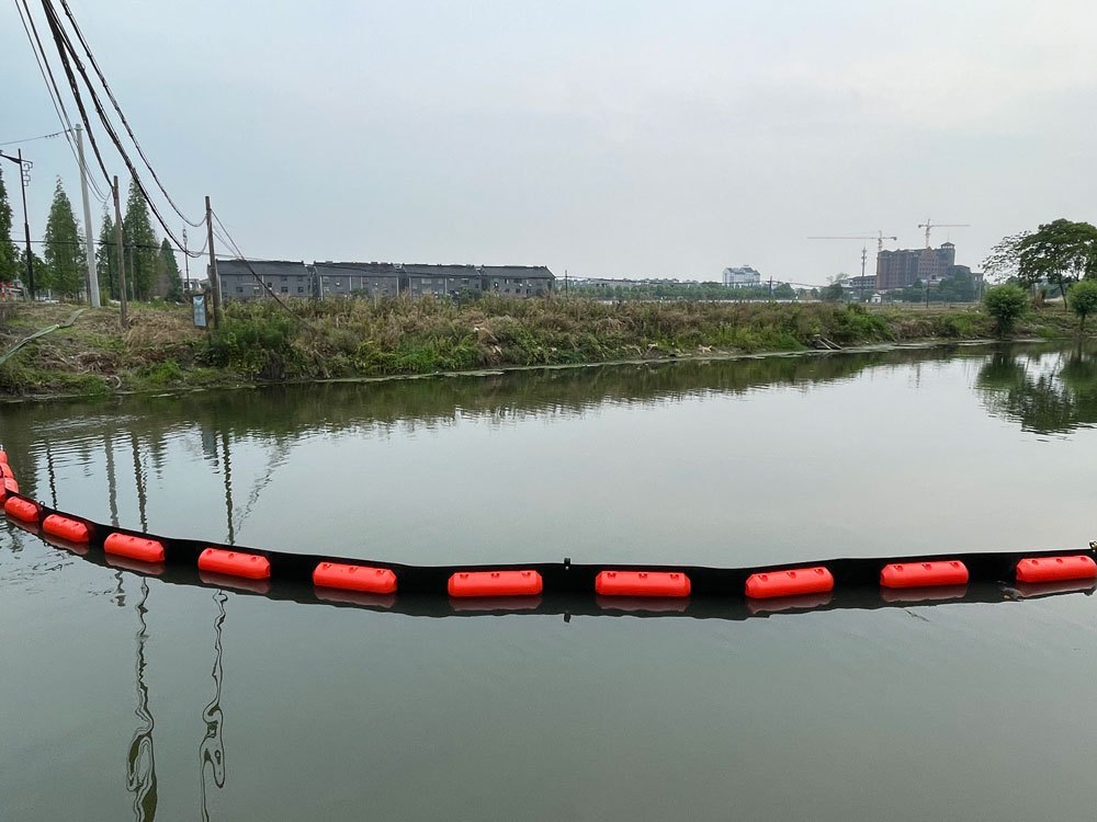 permanent boom barrier deployed in marina for pollution control